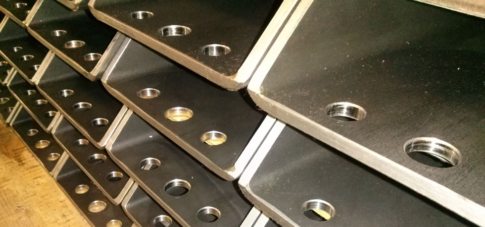 Machined steel plates from a completed production run at Damark Manufacturing, Lomira WI