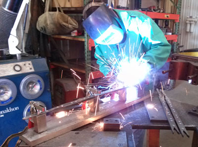 Welder fabricating a custom steel weld assembly at Damark Manufacturing, Lomira WI
